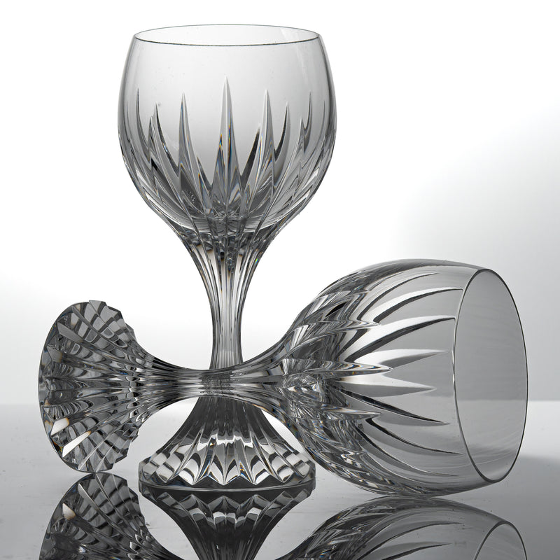 Two Baccarat Massena wine glasses, one standing and one lying on its side