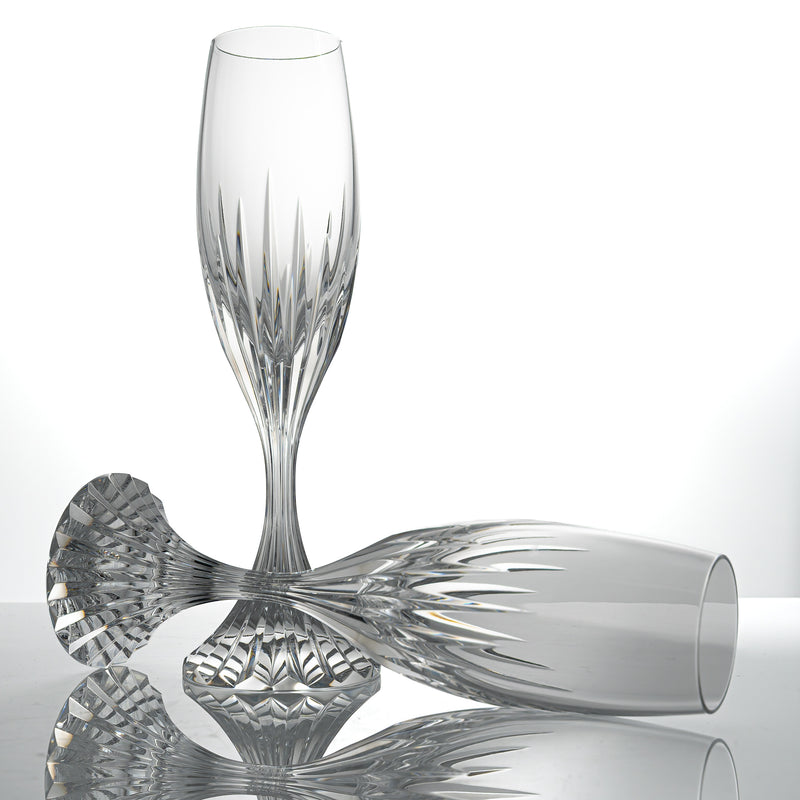 Two Baccarat Massena champagne flutes in clear cut crystal, one standing and one lying on its side