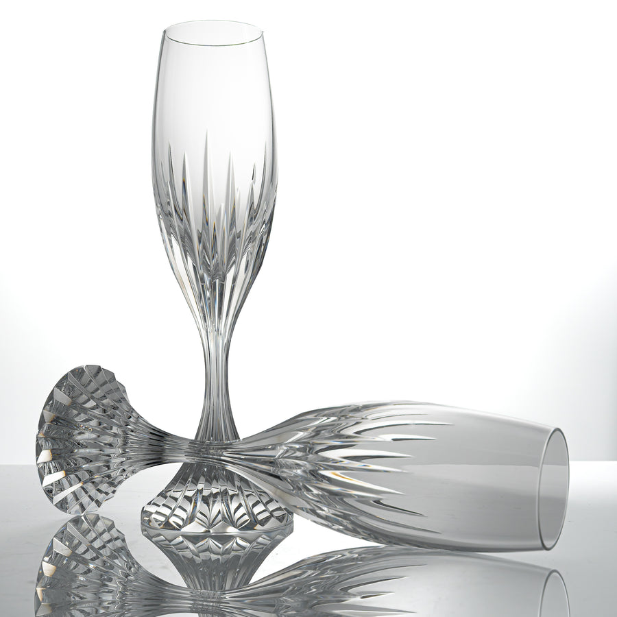 Two Baccarat Massena champagne flutes in clear cut crystal, one standing and one lying on its side