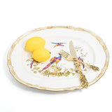Spode Chelsea Bird oval serving platter styled with two lemons and gold flatware